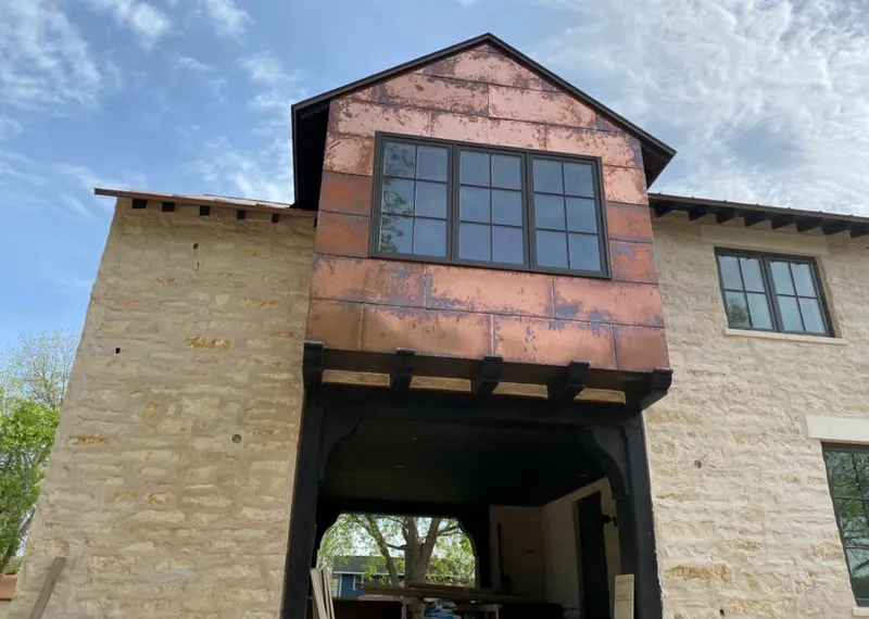 Copper metal panel facade on a stone building for Skylight Installation in Oceola