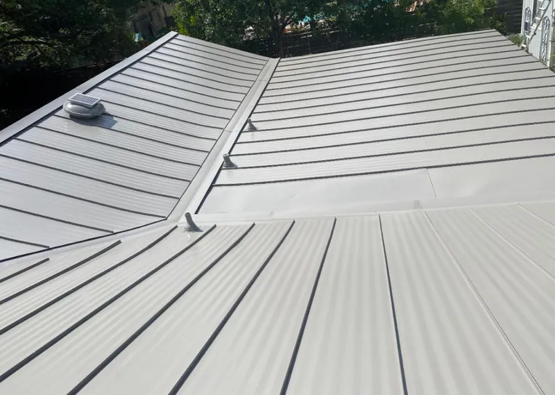 Solar attic fan installed on a metal roof for Roof Ventilation in Oceola